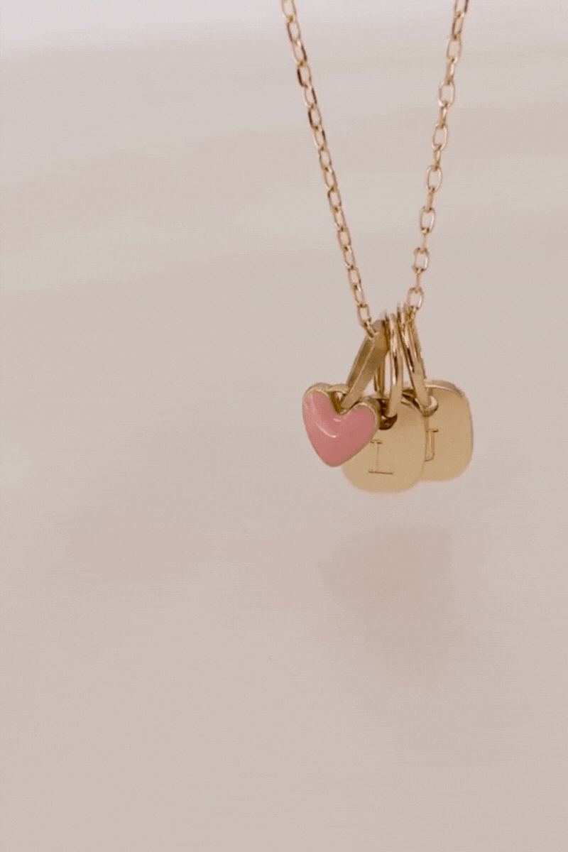 Bluebird co's 9ct solid gold pink heart attached to a solid gold necklace with solid gold initials 