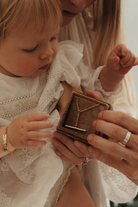 Child and adult looking at a necklace in a box