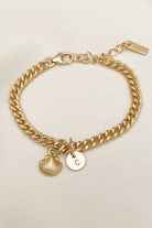 A Cuban Link Bracelet with a Mini Shell Pendant and solid 9ct gold initial pendant on it.