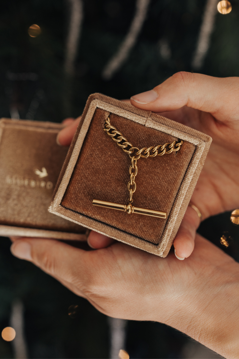 A T-Bar Fob necklace is resting inside a gift box.