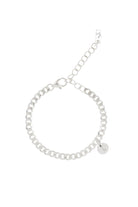 A minimalist silver anklet with a round engraved pendant, photographed on a white background to showcase its craftsmanship and simplicity.