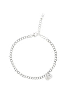 A minimalist silver anklet with round engraved pendants, photographed on a white background to showcase its craftsmanship and simplicity.