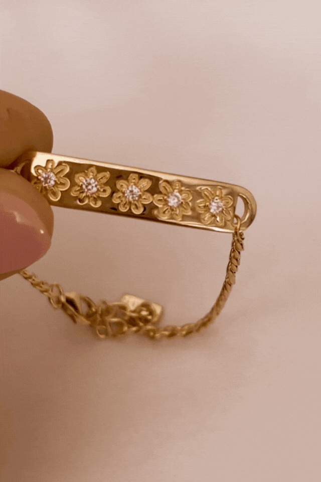 Bluebird Co's daisy bracelet in gold with daisy earrings. 