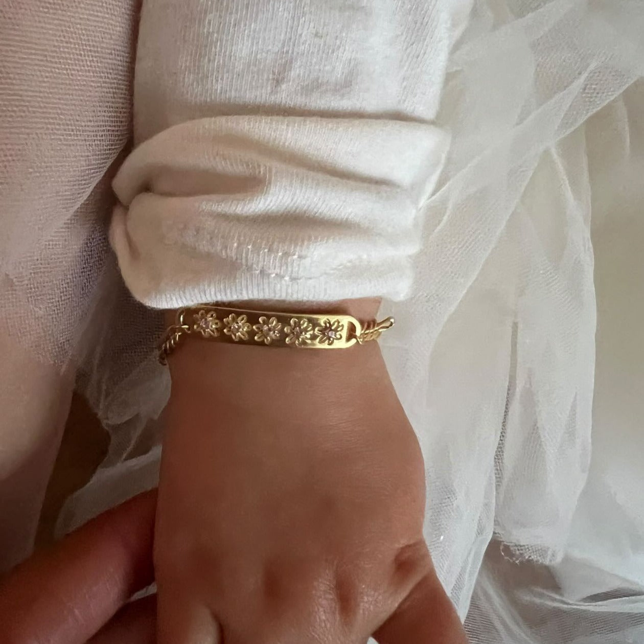 Daisy Bracelet by Bluebird Jewellery in baby size on a young girl's wrist.