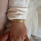 Daisy Bracelet by Bluebird Jewellery in baby size on a young girl's wrist.