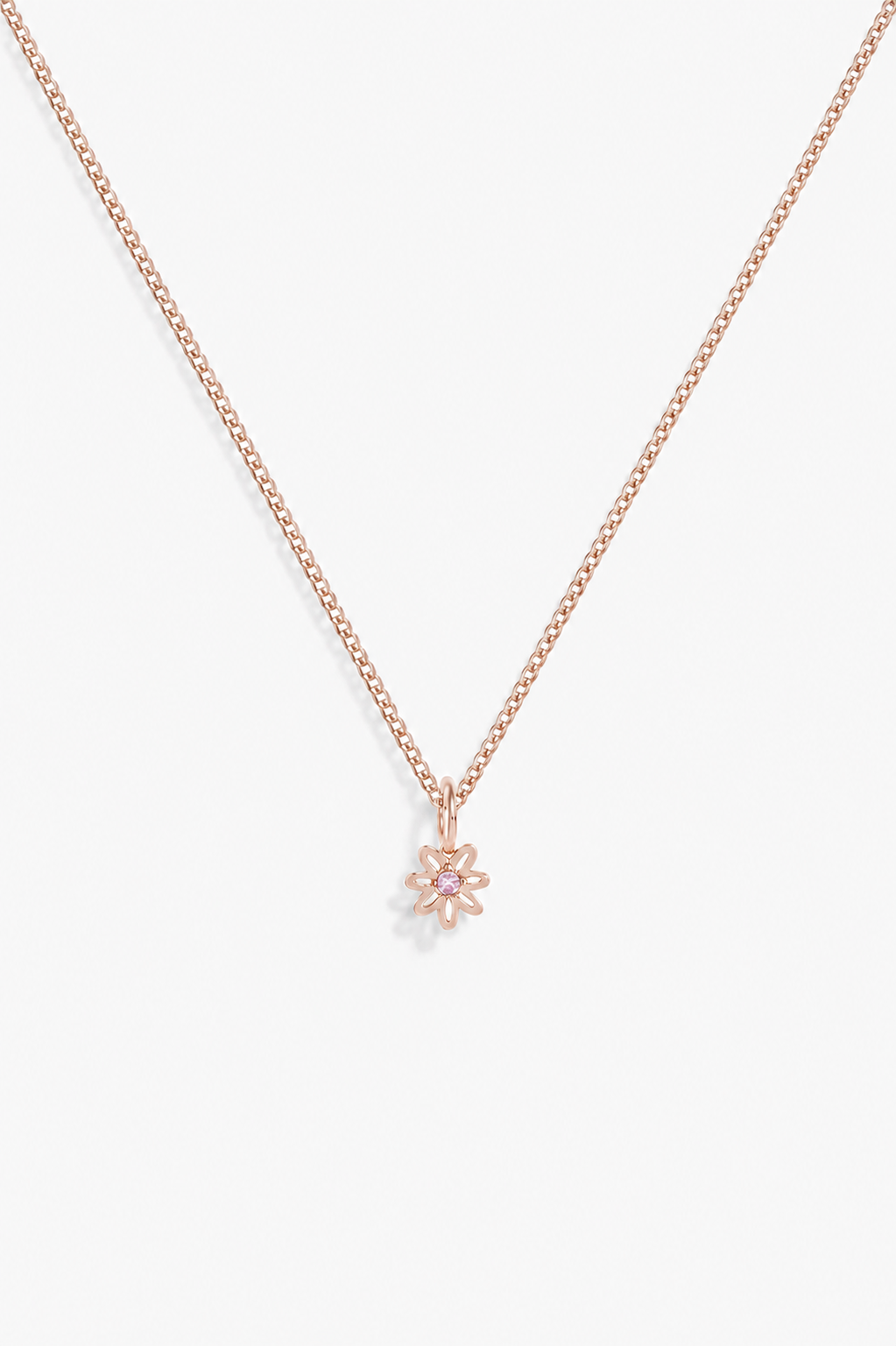 A delicate rose gold chain necklace with a small flower-shaped pendant, displayed against a clean white background.