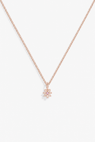 A delicate rose gold chain necklace with a small flower-shaped pendant, displayed against a clean white background.