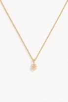 A beautiful dainty daisy pendant with a pink cubic zirconia at its centre is ono a fine curb necklace.  This necklace is perfect for adults and children and can be personalised with an initial pendant.