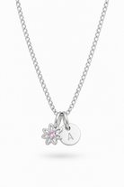 A silver chain necklace with two charms: a small flower charm with a pink gemstone and a round disc charm engraved with the letter 'A', shown on a light gray background.