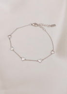An elegant Darling Heart Bracelet from Bluebird Jewellery, designed with five small hearts in a fine chain, perfect for layering with your Bluebird Co collection.