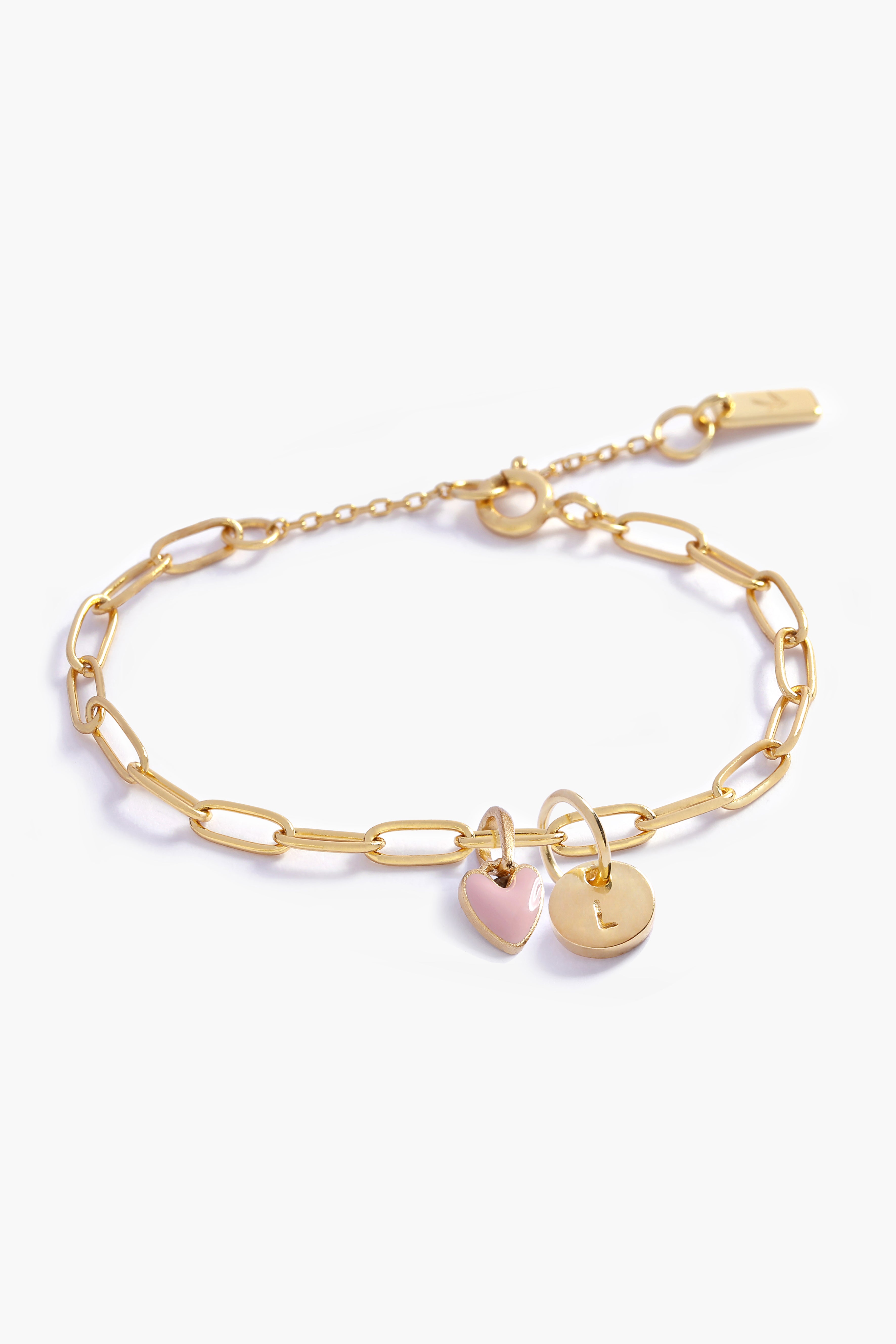 Gold chain bracelet with heart-shaped and round pendants. 
