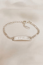 Personalised engraving on a Darling Bracelet .  The engraving is on the front of the bar pendant of the ID bracelet and features the name 'Evie'.