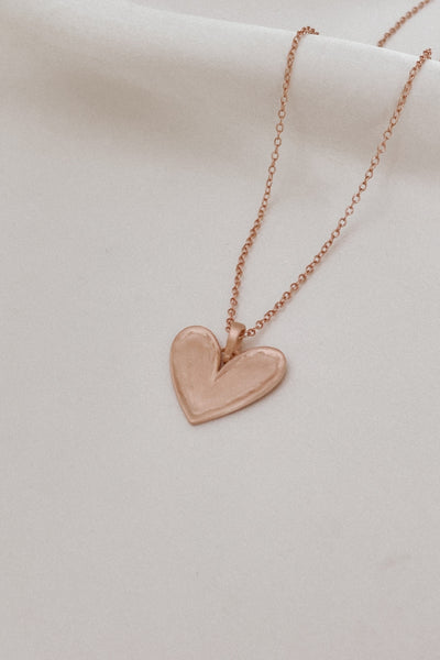 The Darling Necklace in Rose Gold with slightly raised edges and a matte, textured surface.