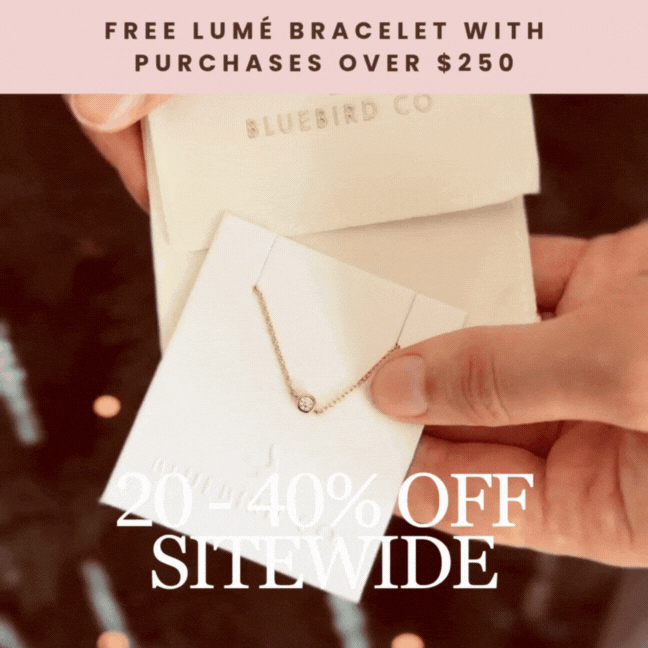 A gold bracelet with cubic zirconia is on