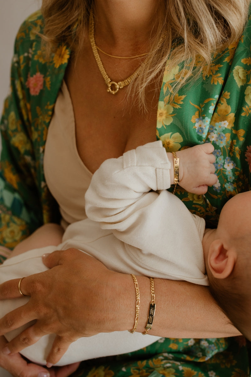 A woman is wearing a Figaro Bracelet alongside a Darling Bracelet by Bluebird Jewellery