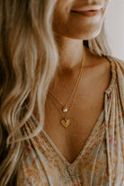 A woman is wearing the best selling Gold Petite Personalised Necklace layered with the Darling Necklace.  Both necklaces are the same length (45+5cm) and are fastened at different lengths on their extension chains to give a lovely closely layered look.