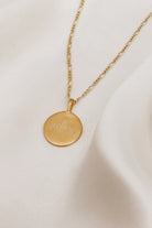 A name is engraved on the front of a Signature necklace pendant.