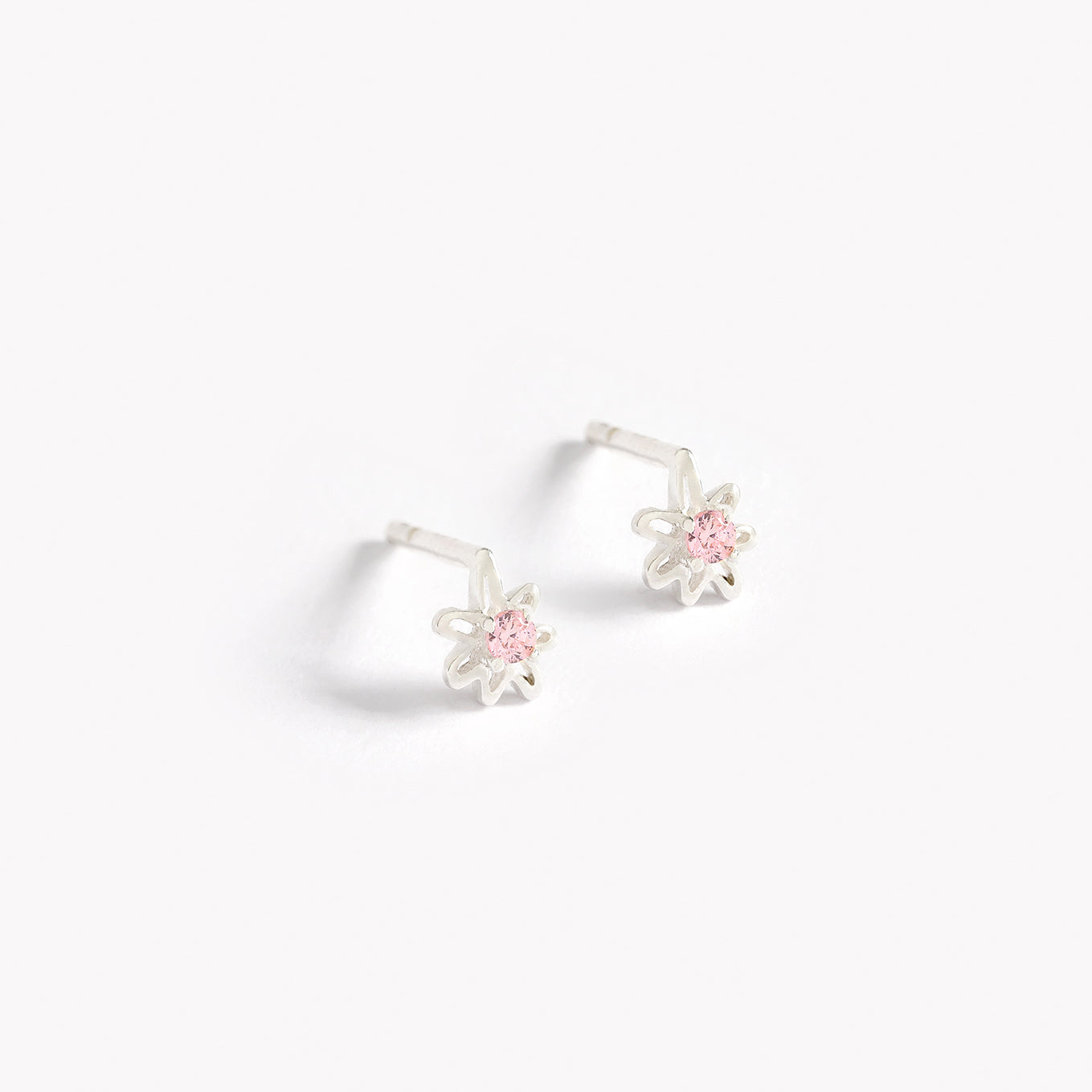 Petite Daisy Studs in sterling silver with pink cubic zirconia stones.