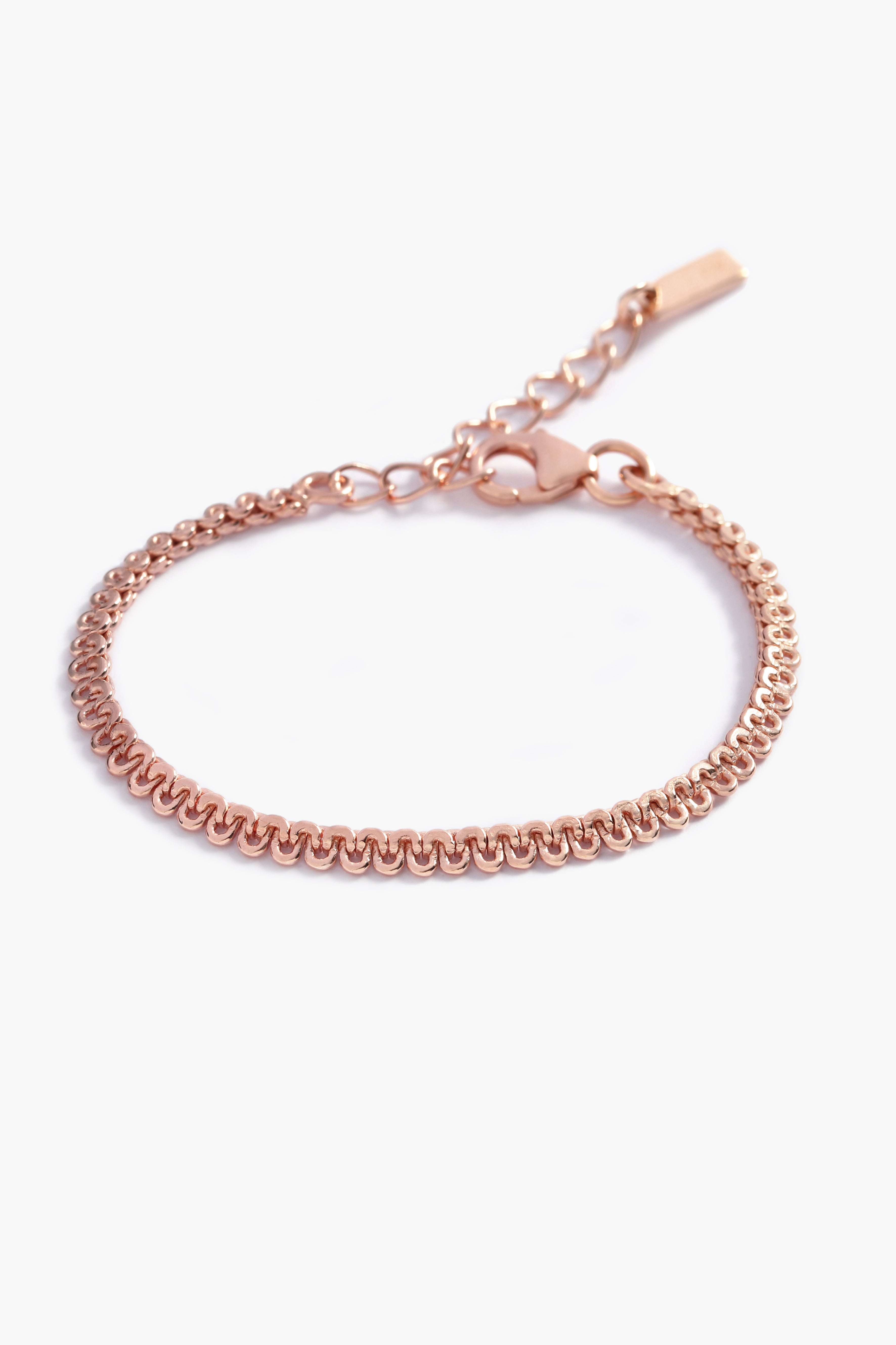 A close-up of The Lace Chain Bracelet, an elegant rose gold bracelet with delicate lace-like detailing and a refined minimalist design by Bluebird Jewellery.