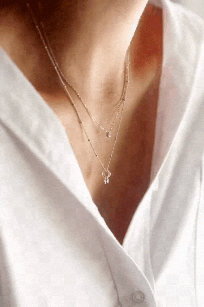 Bluebird Co Lume Necklace Gold layered with the ball chain necklace. 