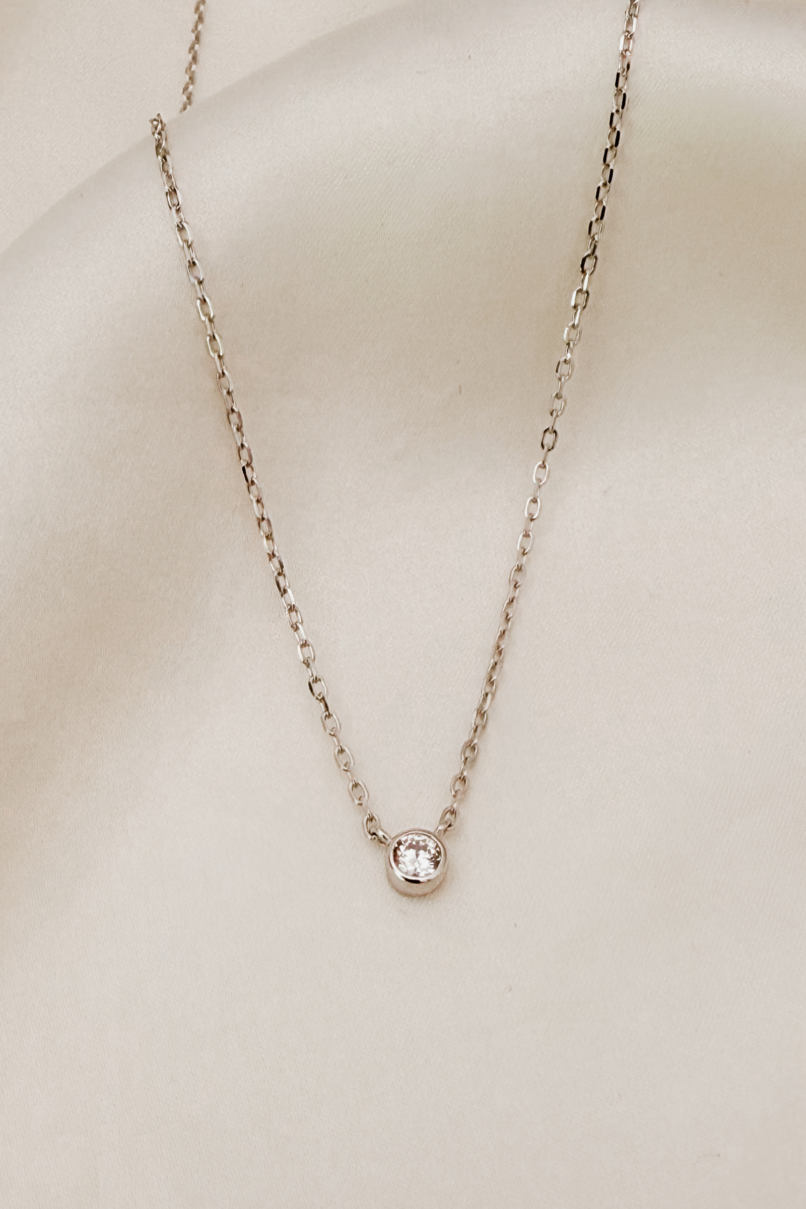 A delicate silver Lumé Necklace by Bluebird Jewellery, designed as a radiant keepsake symbolising light, love, and personal strength.