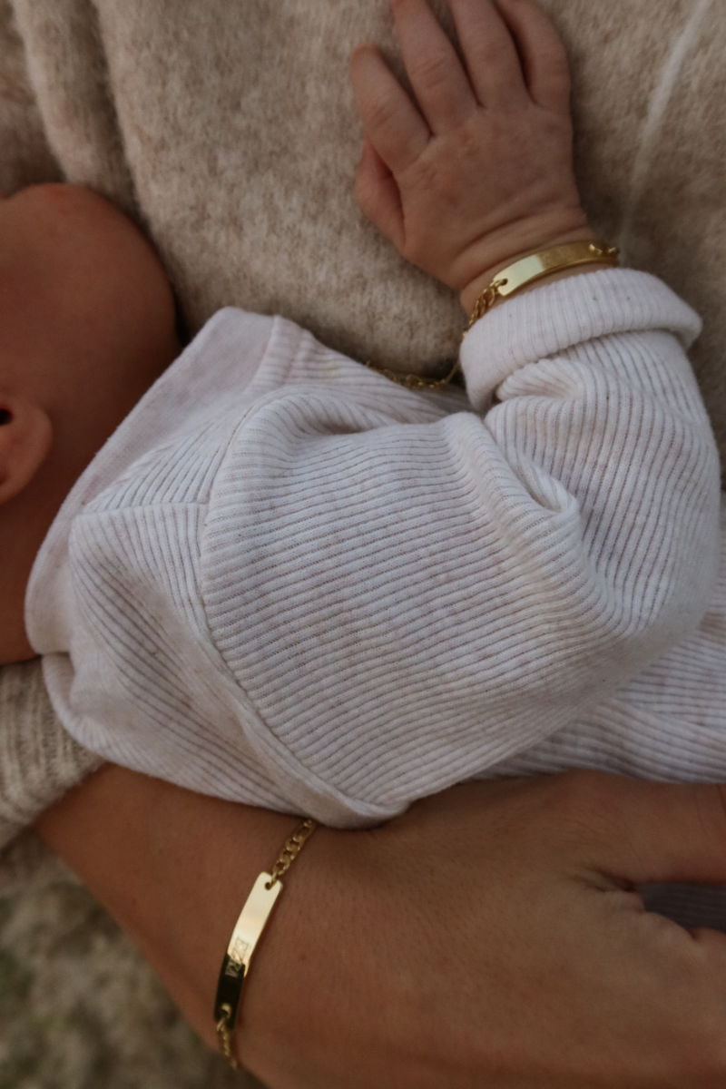Baby and mum both wearing matching Darling Bracelets in Gold by Bluebird Jewellery.