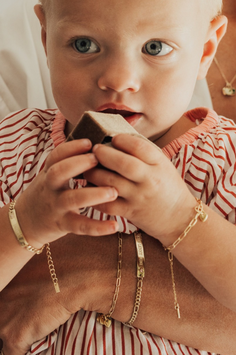 A baby holding a Bluebirde Co velbvet gift box whilst wearing matching bracelets with her mum.  All bracelets are baby and adult sizes and match.