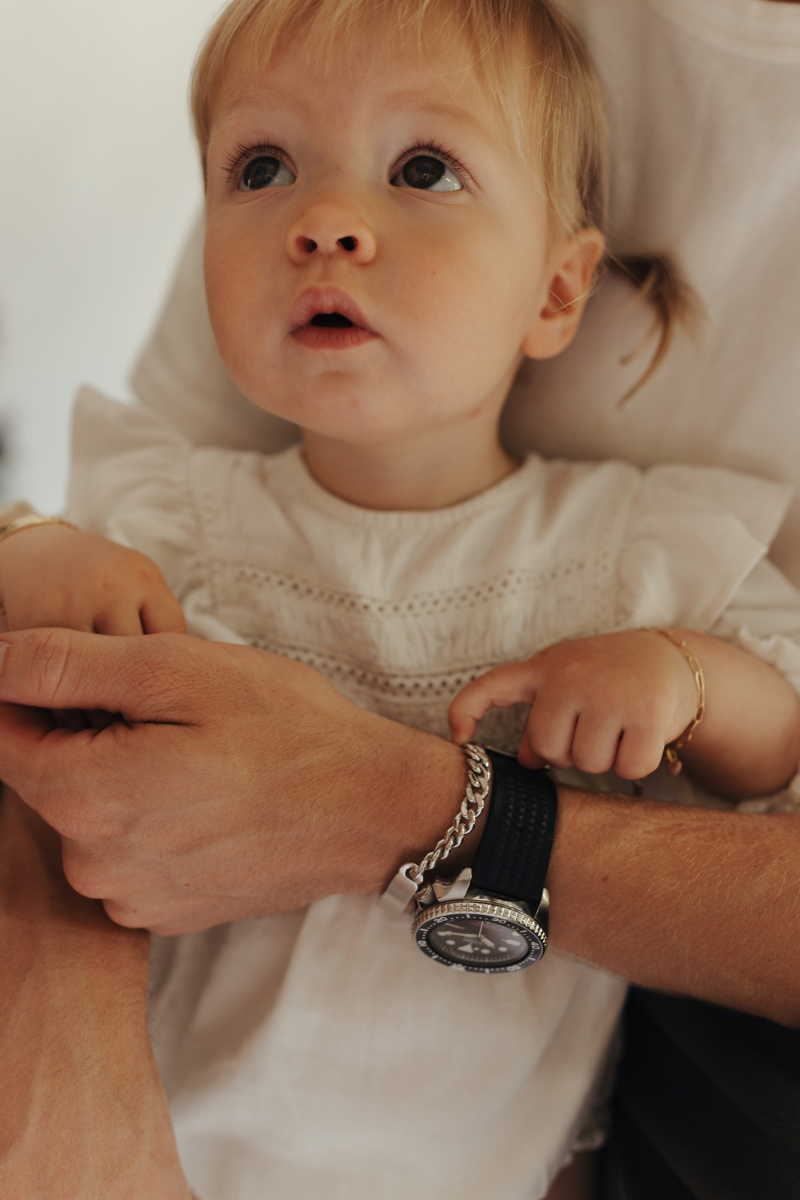 A father is wearing his men’s ID Bracelet. It has engraving on the bottom side of the bracelet. 