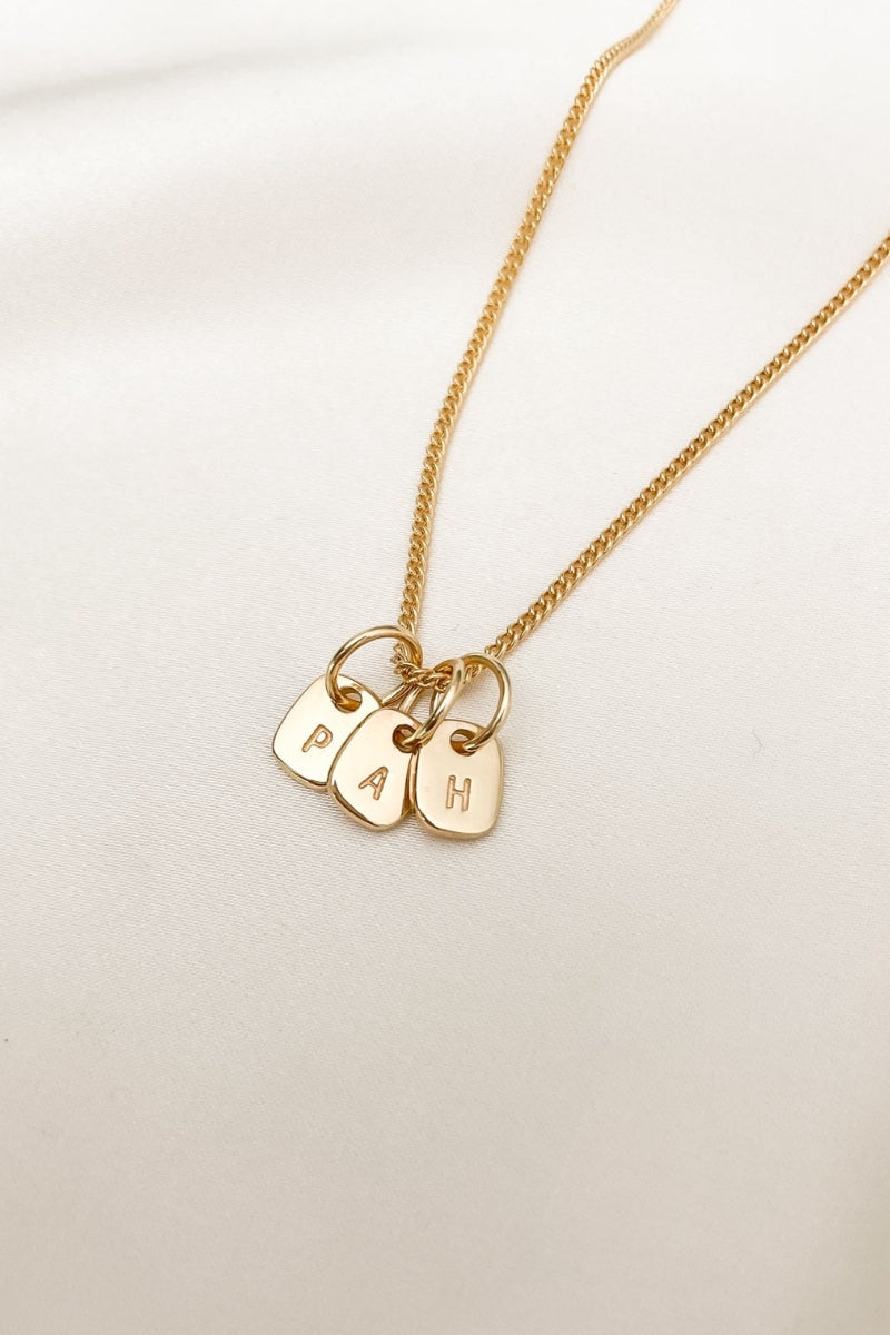 A fine curb chain necklace with the Mini Rectangular Pendants Bluebird Jewellery features gentle curves and a luxe, modern silhouette. Personalised with your chosen letter, it embodies feminine elegance and can be worn beautifully on any necklace, bracelet, or anklet chain.