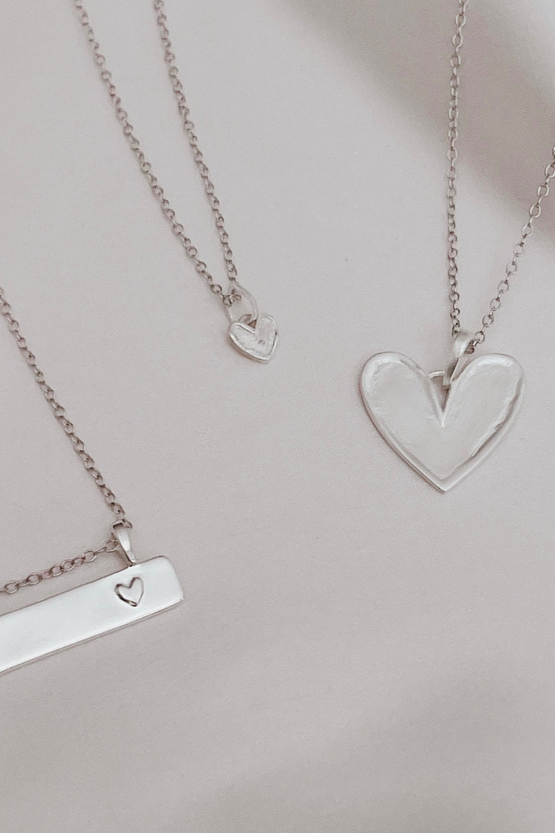 A Darling Bar Necklace, Petite Darling Necklace and Darling Necklace are all shown alongside one another.