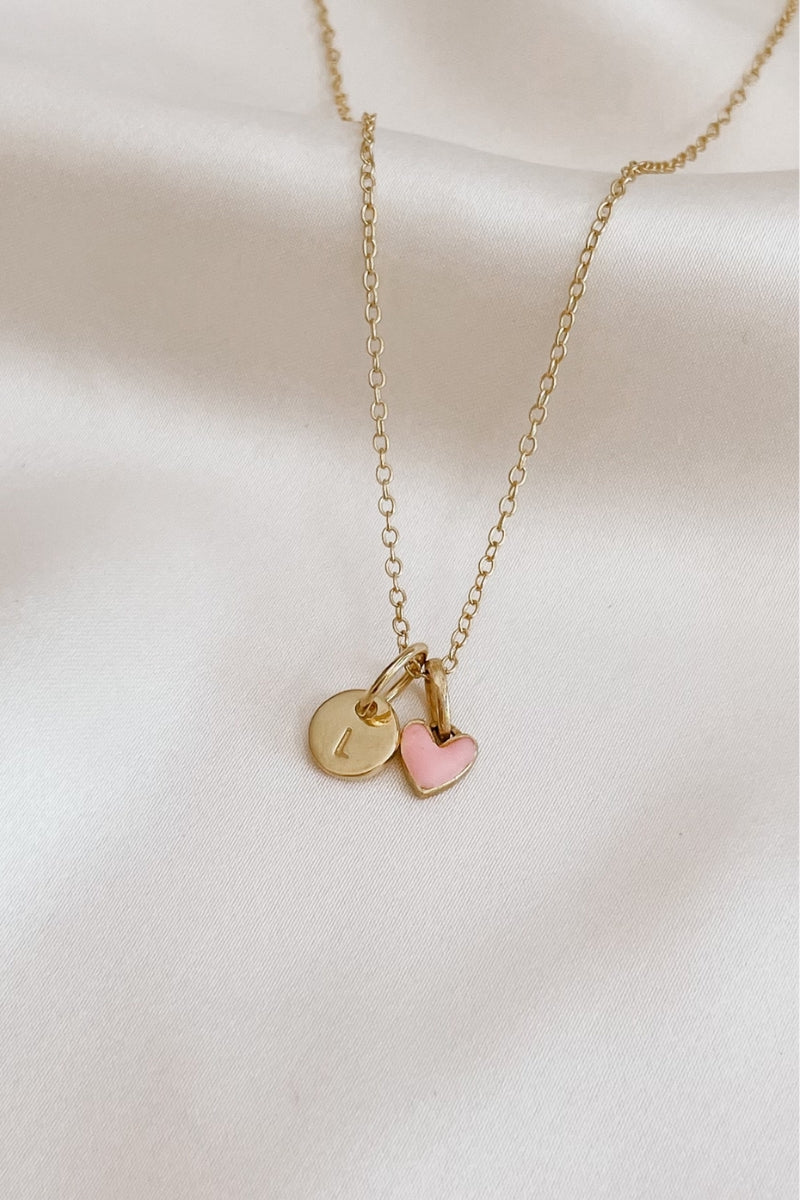 A fine cable chain necklace with a classic round Petite Gold Vermeil Initial Pendant and pink darling pendant from Bluebird Jewellery, personalised with your chosen letter and designed to be worn elegantly on any necklace, bracelet, or anklet chain.