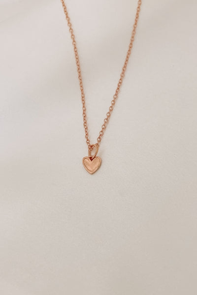 Rose Gold Petite Darling Necklace with an organic shaped petite heart pendant on a fine cable chain necklace.