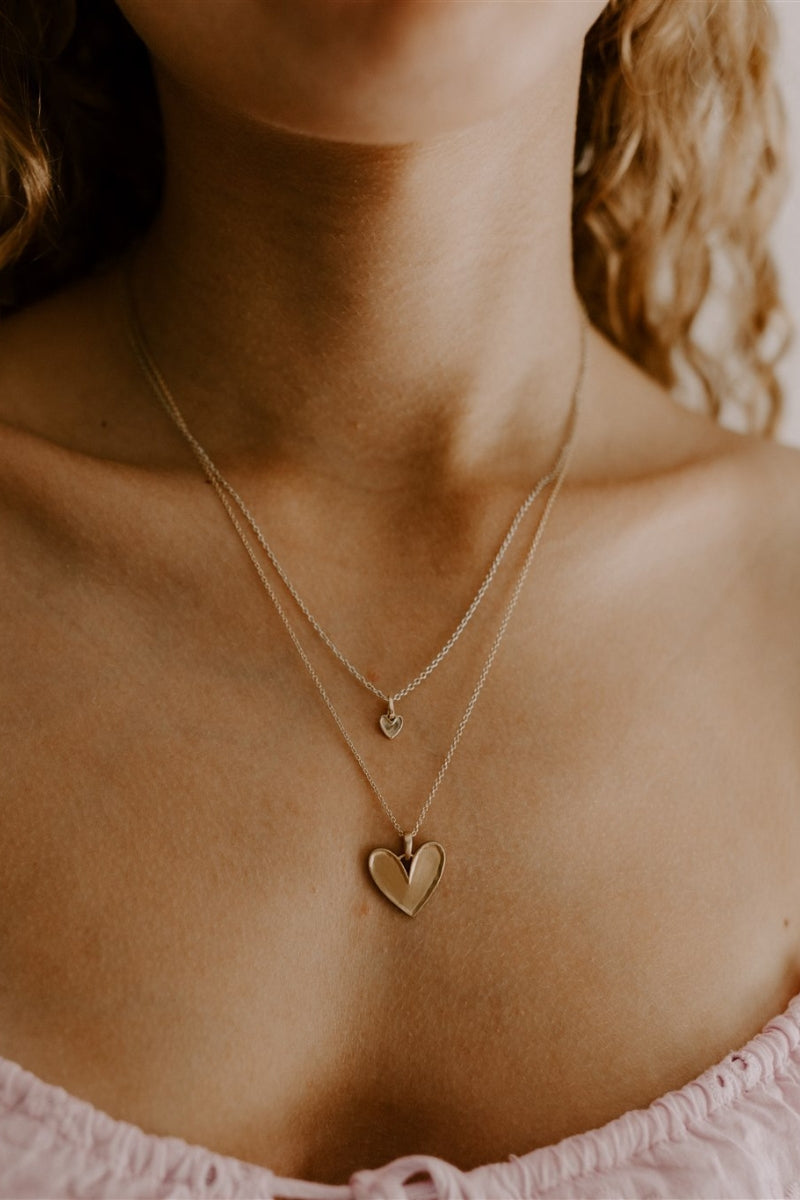 A teenage girl is wearing the Petite Darling Necklace Layered with the Darling Necklace 