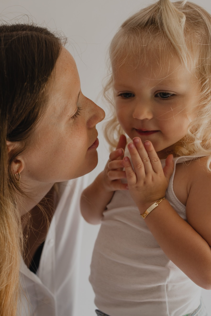 A child wearing the Bluebird Jewellery Pink Darling Bracelet gold, designed with a pink heart charm as a meaningful  bracelet and keepsake.