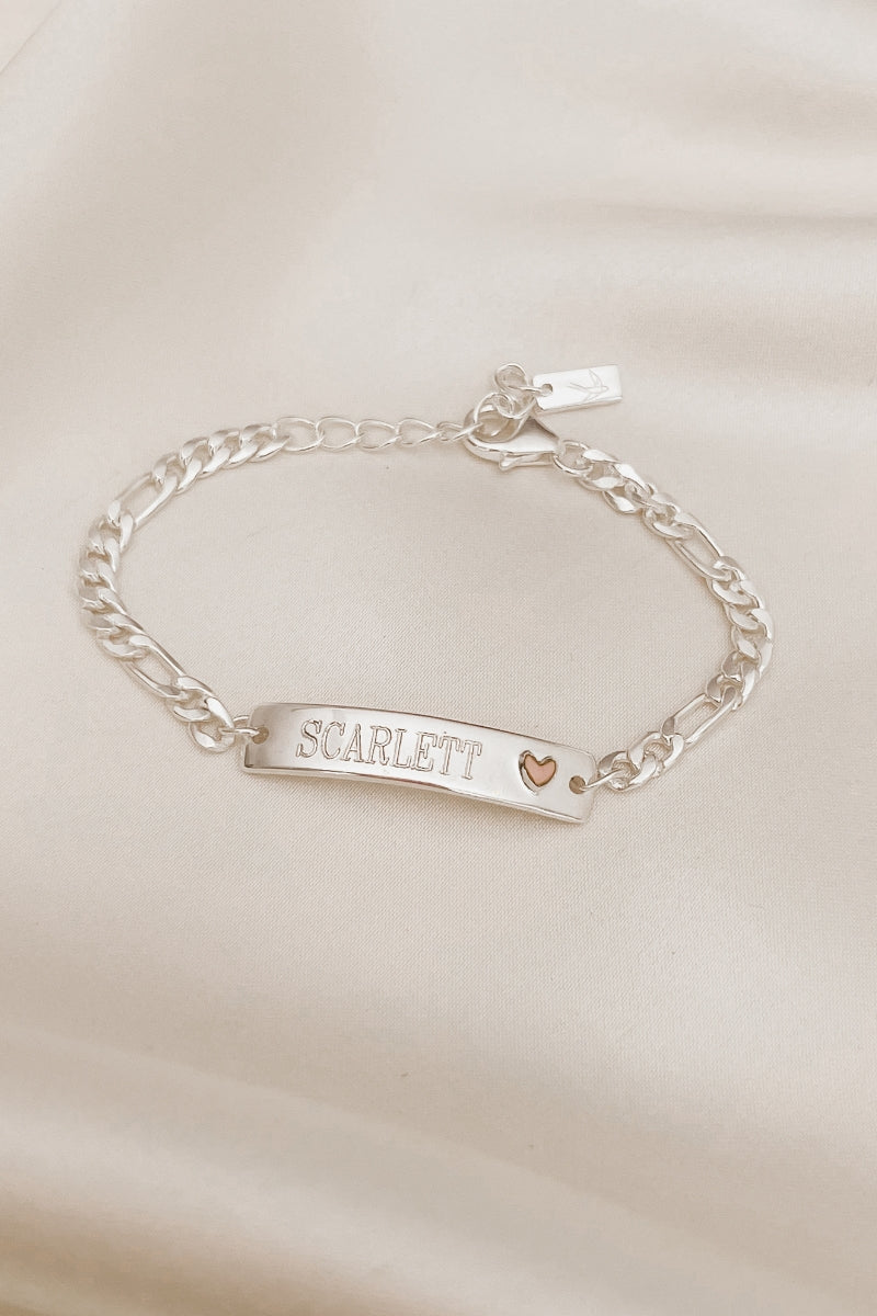 A Pink Darling Bracelet is personalised with engraving of a name on the front of the bracelet.