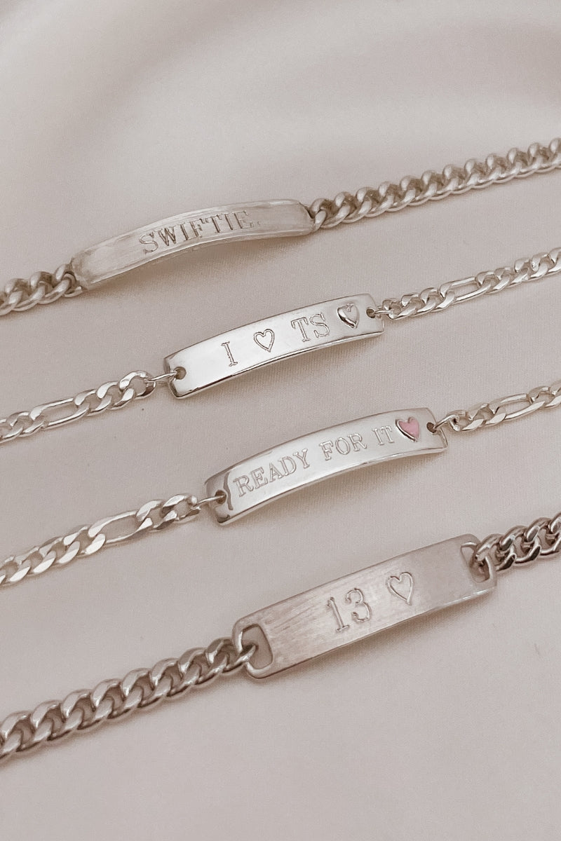The Pink Darling Bracelet is engraved with 'Ready For It' and features alongside three other engravable bracelet styles.  The top bracelet is a Signature Bracelet.  The next bracelet is a Darling Bracelet and then a Pink Darling Bracelet and a Classic ID Bracelet by Bluebird Jewellery.
