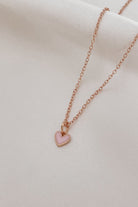 A closer look at the Pink Petite Darling Necklace which shows the small pink heart pendant on the fine cable chain necklace.