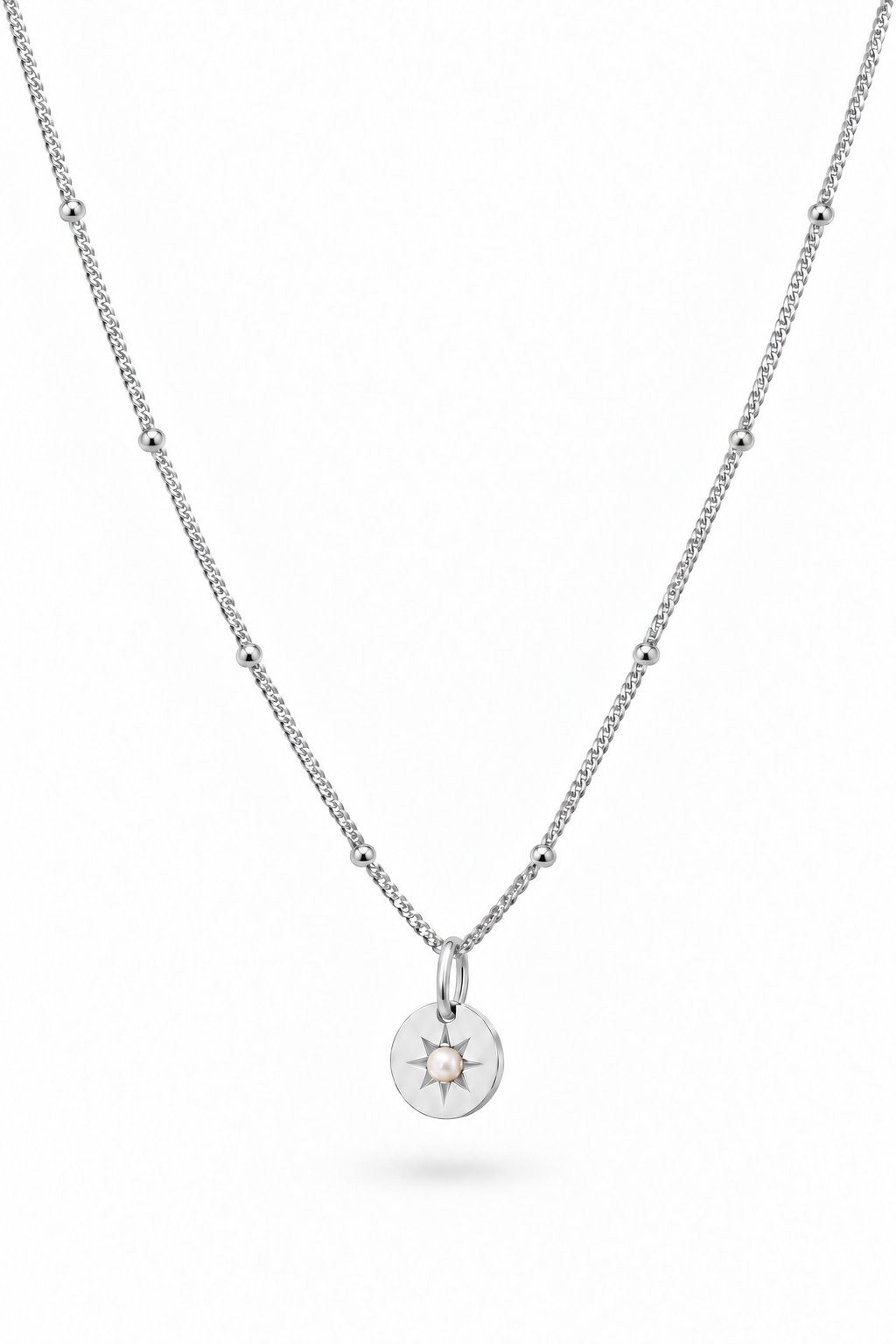 A delicate sterling silver chain necklace with small pearl accents and a circular sunburst pendant, shown on a clean white background.