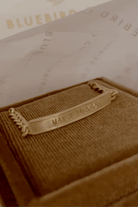 Bluebird Co's signature bracelet in gold placed in velvet box. 