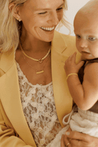 Bluebird Co's signature bar necklace and signature statement necklace and signature bracelet in gold 