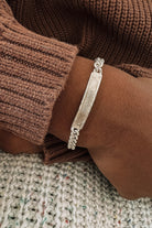 A Signature Bracelet in child length has the name 'Rabboni' engraved on the front surface of the ID bar pendant on the bracelet.  These bracelets are custom engraved for each person.