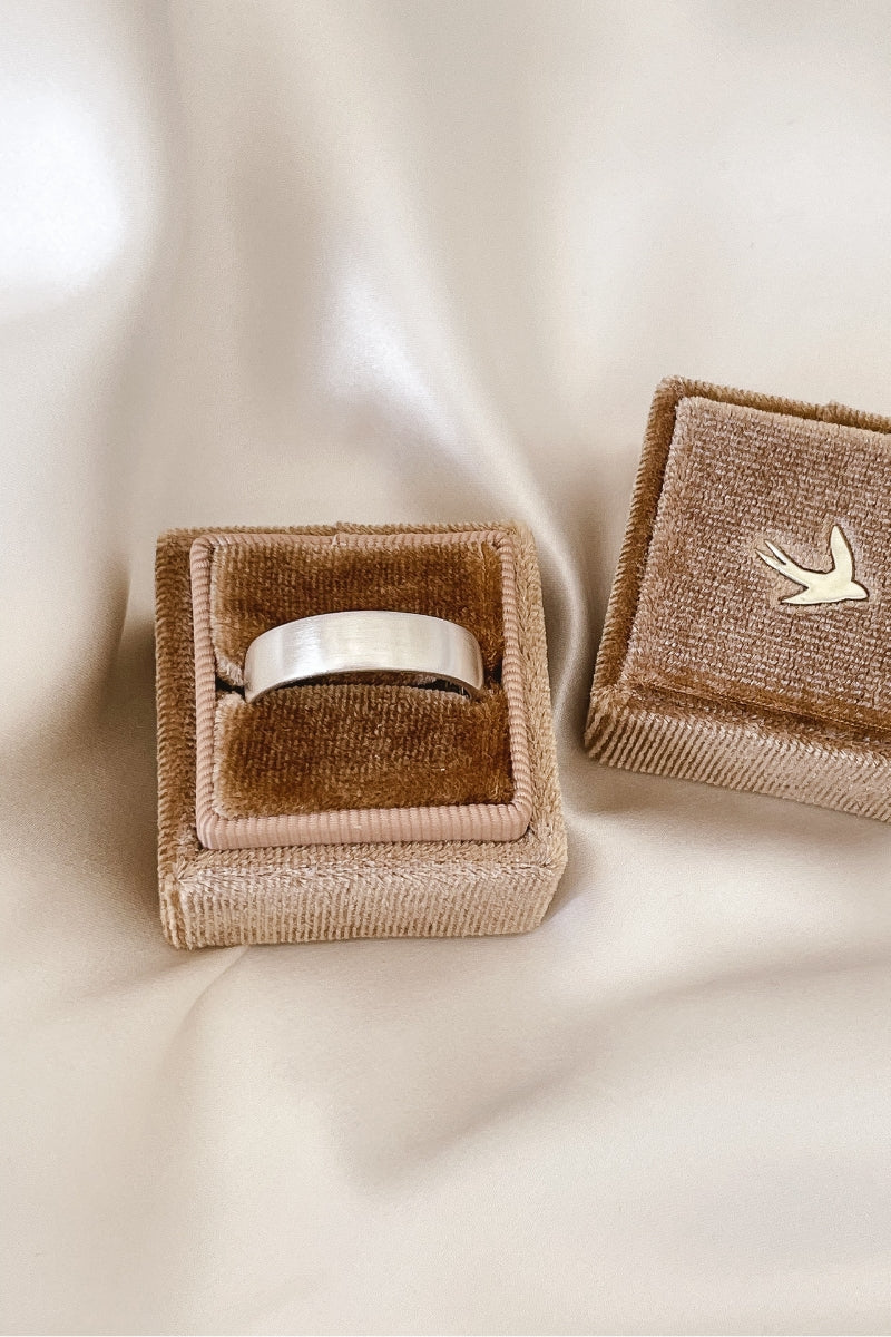 A sterling silver Signature Men's Ring in a velvet Bluebird Co ring box.