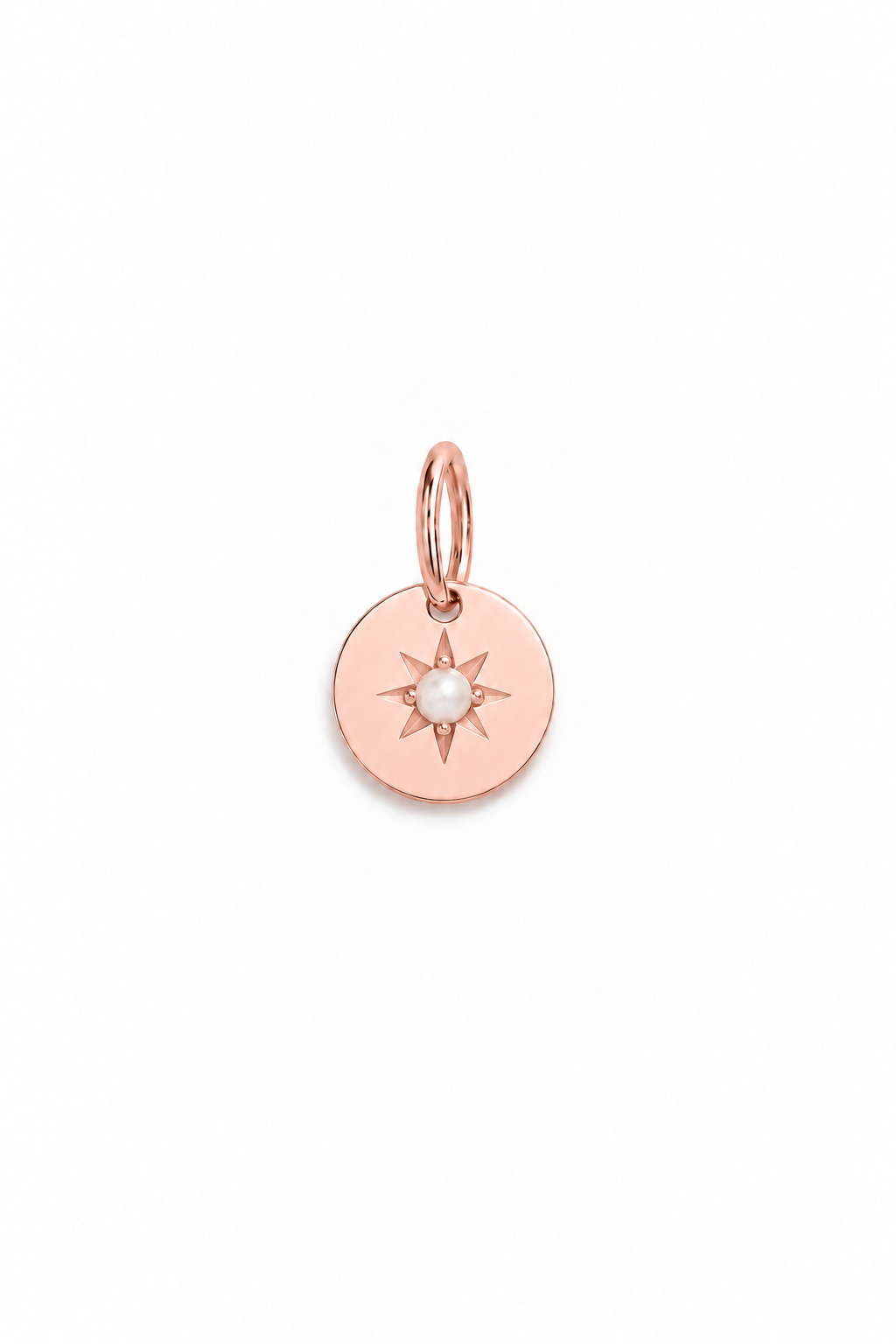A rose gold pendant with a vintage inspired star and seed pearl at its centre.
