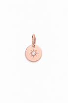 A rose gold pendant with a vintage inspired star and seed pearl at its centre.
