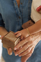 A close-up of the Solid Gold Bracelet, signature rings and gold cuban chain bracelet by Bluebird Jewellery, crafted in fine gold as a personalised piece for both casual and refined occasions.