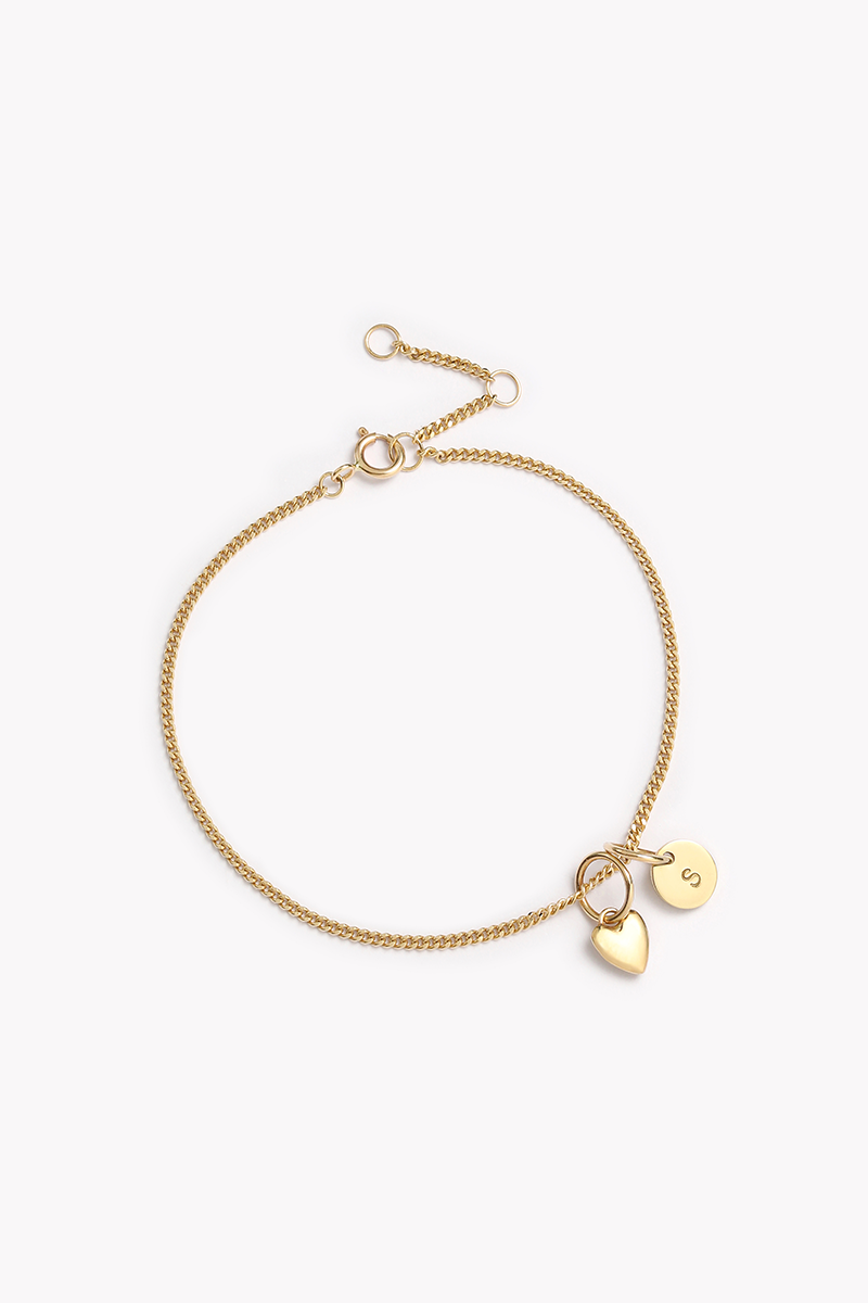 The Solid Gold Bracelet with heart and initial pendant by Bluebird Jewellery, a fine and elegant personalised bracelet designed for everyday wear and timeless sophistication.