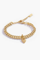 A gold Sweetheart Cuban Link Chain Bracelet featuring a polished heart charm, crafted as a modern and elegant fine jewellery piece.