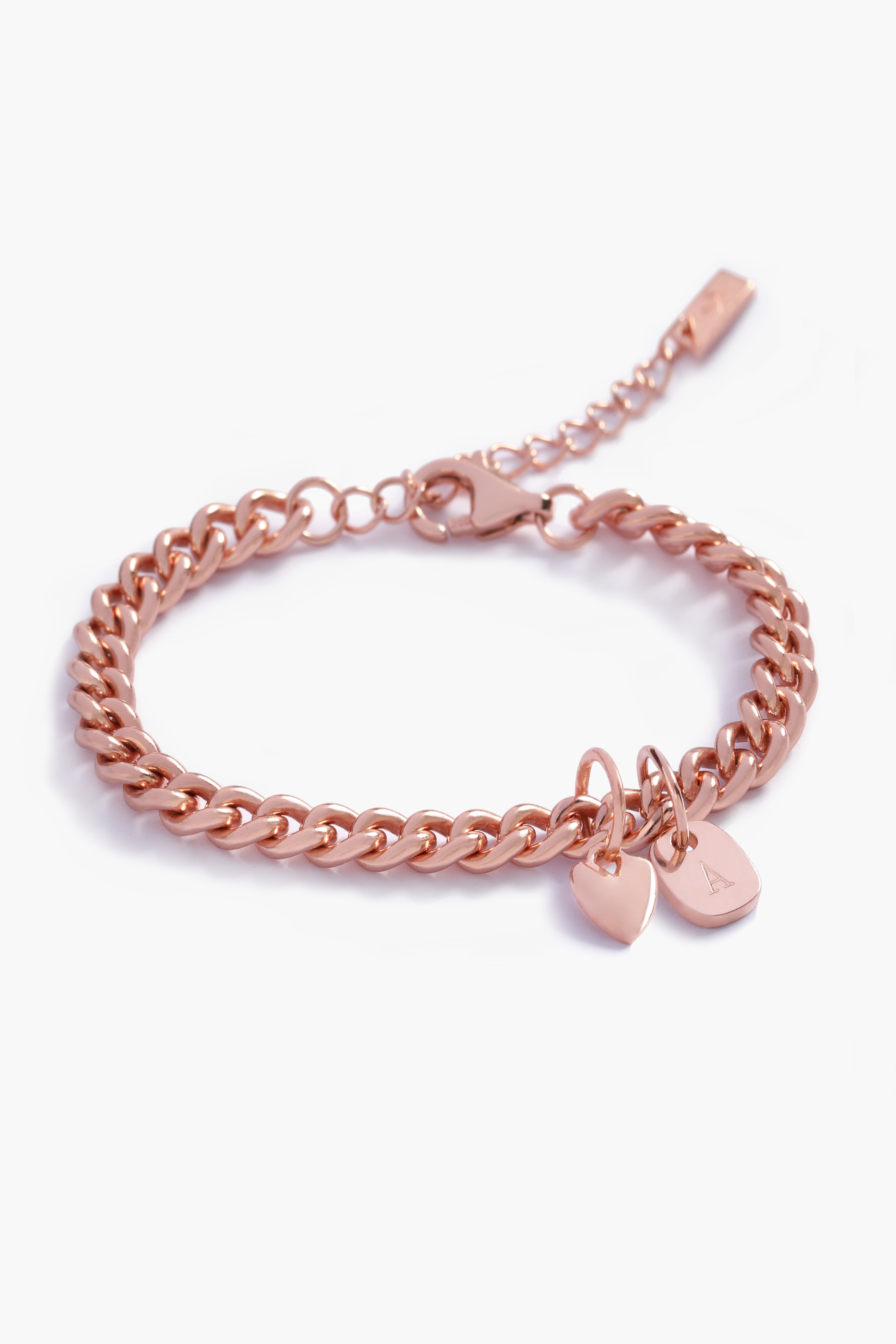 A detailed image of a rose gold Sweetheart Cuban Link Chain Bracelet with a heart charm and engraved rectangular pendant, designed as elegant personalised jewellery.