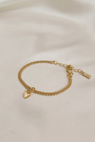 A close-up of The Lace Chain Bracelet adorned with a heart charm, crafted as a meaningful keepsake piece.