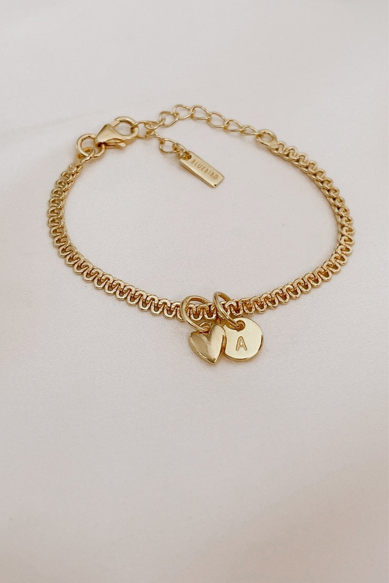 A close-up of The Lace Chain anklet adorned with a heart charm and personalised initial pendant, crafted as a meaningful keepsake piece.